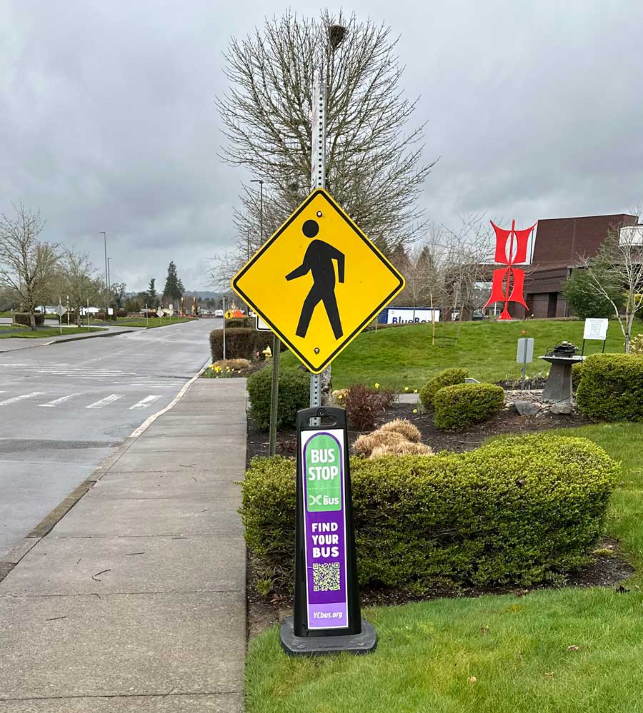A temporary bus stop sign for the Yamhill County Transit bus.
